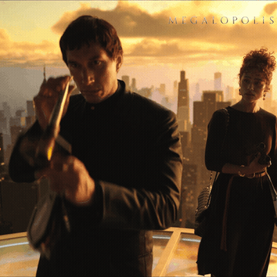 A Man And A Woman Are Standing In Front Of A City And The Word Megalopolis Is On The Bottom GIF