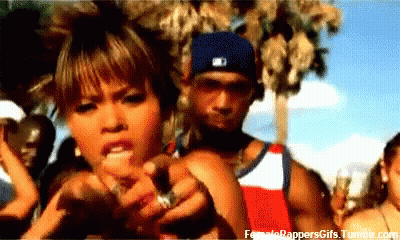 A Man And A Woman Are Standing In Front Of A Crowd . The Man Is Wearing A Nike Hat . GIF