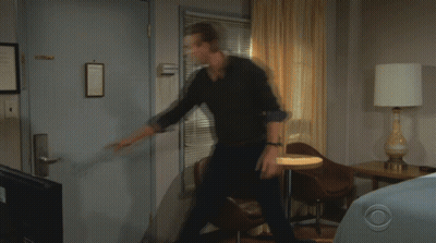 A Man And A Woman Are Standing In Front Of A Door With The Number 1136 On It GIF
