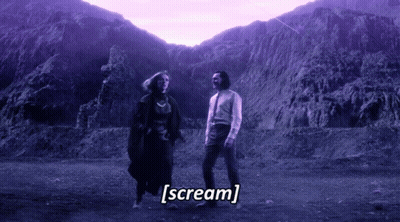 A Man And A Woman Are Standing In Front Of A Mountain And The Words Scream Are Written Below Them GIF