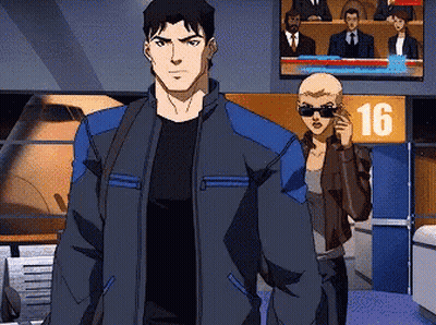 A Man And A Woman Are Standing In Front Of A Sign That Says 16 On It GIF