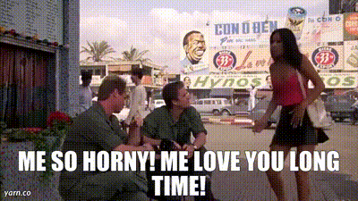 A Man And A Woman Are Standing In Front Of A Sign That Says Con O Ben GIF