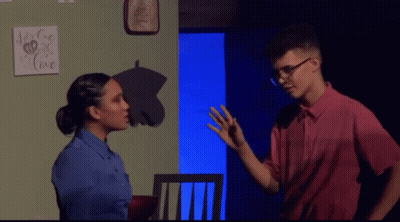 A Man And A Woman Are Standing In Front Of A Sign That Says " It 'S For Love " GIF