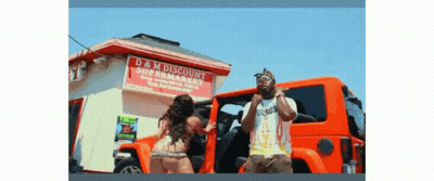 A Man And A Woman Are Standing In Front Of A Store Called D & M Discount GIF