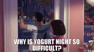 A Man And A Woman Are Standing In Front Of A Window . The Woman Is Asking The Man Why Is Yogurt Night So Difficult GIF