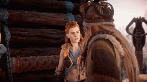 A Man And A Woman Are Standing In Front Of A Wooden Building GIF