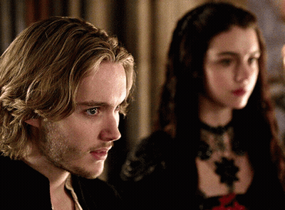 A Man And A Woman Are Standing Next To Each Other And Looking At Something GIF