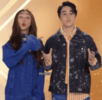 A Man And A Woman Are Standing Next To Each Other And Making Funny Faces GIF