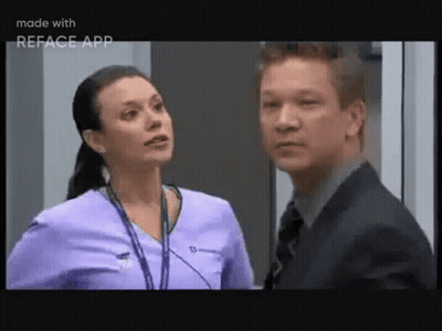 A Man And A Woman Are Standing Next To Each Other And Talking . GIF