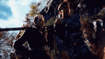 A Man And A Woman Are Standing Next To Each Other And Talking . GIF