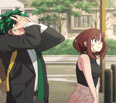 A Man And A Woman Are Standing Next To Each Other And The Man Is Covering His Face GIF