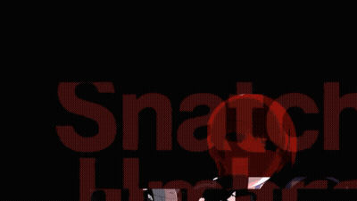 A Man And A Woman Are Standing Next To Each Other And The Man Is Holding A Red Object GIF