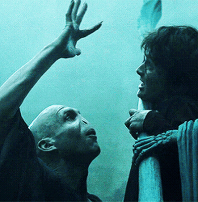 A Man And A Woman Are Standing Next To Each Other And The Man Is Reaching Up Towards The Woman GIF