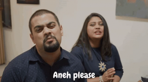 A Man And A Woman Are Standing Next To Each Other And The Man Is Saying " Aneh Please " GIF