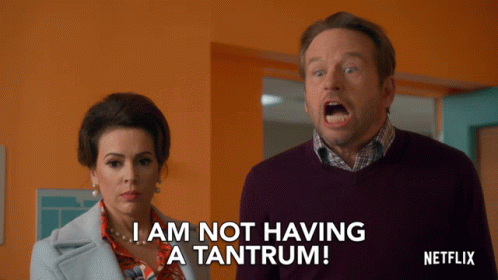 A Man And A Woman Are Standing Next To Each Other And The Man Is Saying I Am Not Having A Tantrum GIF