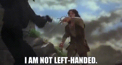 A Man And A Woman Are Standing Next To Each Other And The Man Is Saying `` I Am Not Left-Handed '' . GIF