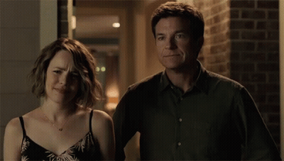 A Man And A Woman Are Standing Next To Each Other And The Man Is Saying " Oh Boy " GIF