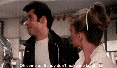 A Man And A Woman Are Standing Next To Each Other And The Man Is Saying Oh Come On Sandy Don 'T Make Me Laugh GIF