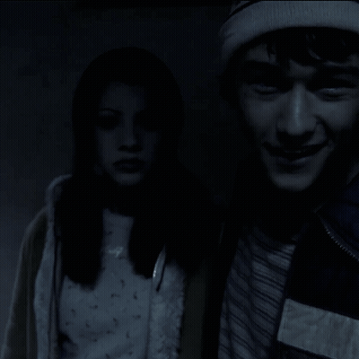 A Man And A Woman Are Standing Next To Each Other And The Man Is Smiling GIF