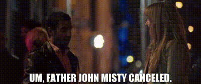 A Man And A Woman Are Standing Next To Each Other And The Man Is Talking To The Woman . GIF