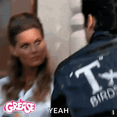 A Man And A Woman Are Standing Next To Each Other And The Man Is Wearing A Jacket That Says " T-Bird " GIF