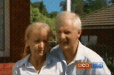 A Man And A Woman Are Standing Next To Each Other And The Man Is Wearing A Shirt That Says Acca GIF