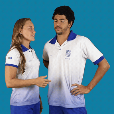 A Man And A Woman Are Standing Next To Each Other And The Man Is Wearing A Shirt That Says Natacao GIF