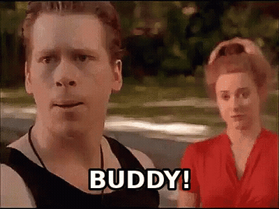 A Man And A Woman Are Standing Next To Each Other And The Man Says Buddy . GIF