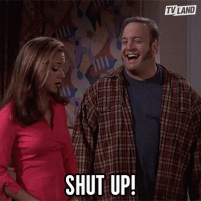A Man And A Woman Are Standing Next To Each Other And The Man Says Shut Up GIF