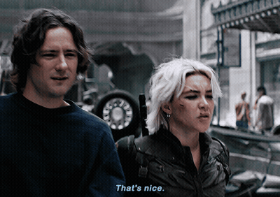 A Man And A Woman Are Standing Next To Each Other And The Man Says That 'S Nice GIF