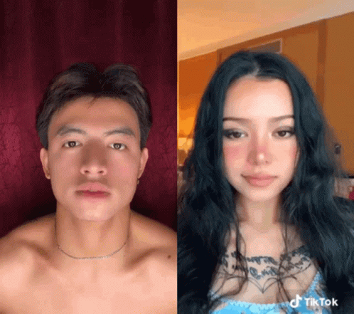 A Man And A Woman Are Standing Next To Each Other And The Woman Has A Tattoo On Her Chest GIF