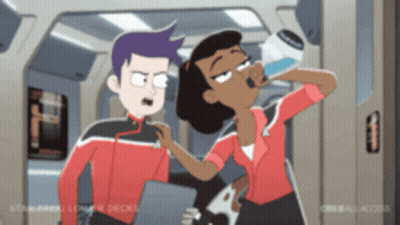 A Man And A Woman Are Standing Next To Each Other And The Woman Is Drinking Water GIF