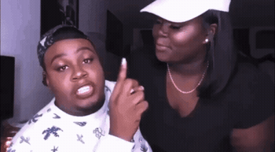 A Man And A Woman Are Standing Next To Each Other And The Woman Is Pointing At The Man 'S Finger . GIF