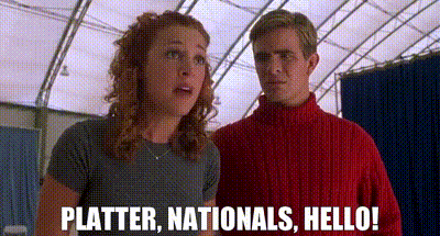 A Man And A Woman Are Standing Next To Each Other And The Woman Is Saying `` Platter , Nationals , Hello '' . GIF
