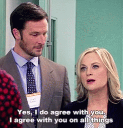 A Man And A Woman Are Standing Next To Each Other And The Woman Is Saying Yes I Do Agree GIF