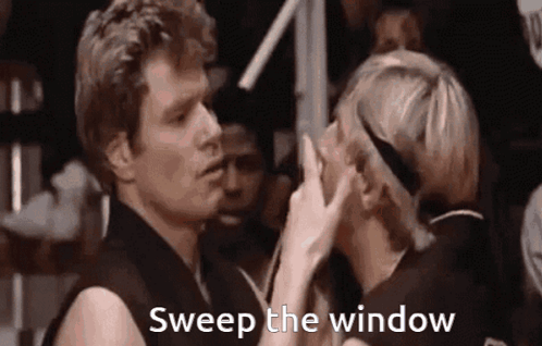 A Man And A Woman Are Standing Next To Each Other And The Woman Is Touching The Man 'S Nose . GIF
