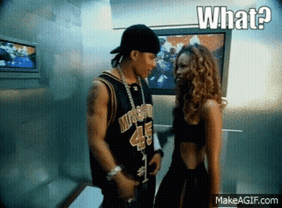 A Man And A Woman Are Standing Next To Each Other And The Woman Is Wearing A Jersey With The Number 45 On It GIF