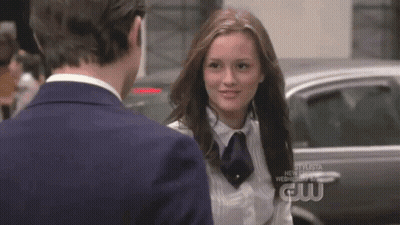 A Man And A Woman Are Standing Next To Each Other And The Woman Is Wearing A White Shirt And Tie . GIF