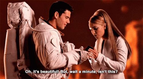 A Man And A Woman Are Standing Next To Each Other And The Woman Says Oh It 'S Beautiful . GIF