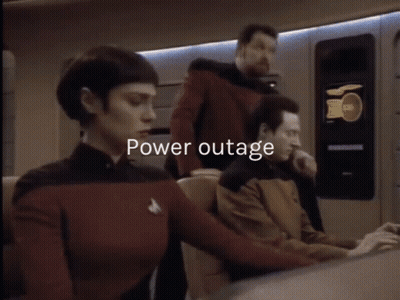 A Man And A Woman Are Standing Next To Each Other And The Words Power Outage Are Displayed Above Them GIF