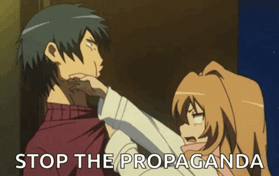 A Man And A Woman Are Standing Next To Each Other And The Words Stop The Propaganda Are Visible GIF