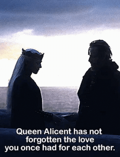 A Man And A Woman Are Standing Next To Each Other Holding Hands . GIF