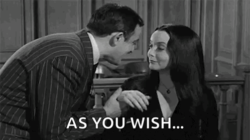 A Man And A Woman Are Standing Next To Each Other In A Black And White Photo . GIF
