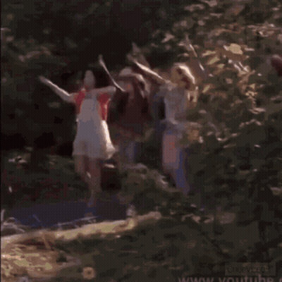 A Man And A Woman Are Standing Next To Each Other In A Blurry Photo . GIF