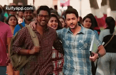 A Man And A Woman Are Standing Next To Each Other In A Crowded Street . GIF