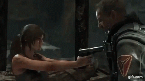 A Man And A Woman Are Standing Next To Each Other In A Dark Room . GIF