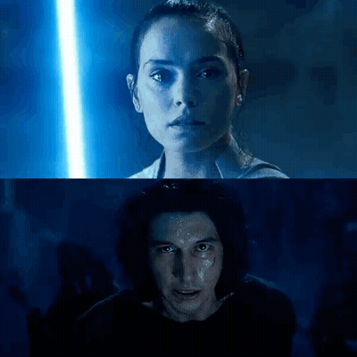 A Man And A Woman Are Standing Next To Each Other In A Dark Room With A Blue Light Behind Them . GIF