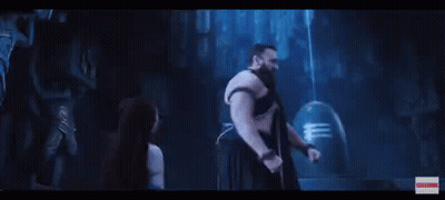 A Man And A Woman Are Standing Next To Each Other In A Dark Room With A Blue Light Coming Out Of Their Head . GIF