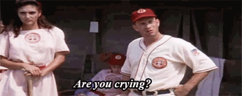 A Man And A Woman Are Standing Next To Each Other In A Dugout . GIF