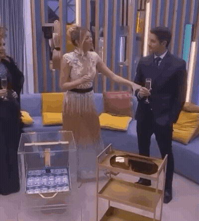 A Man And A Woman Are Standing Next To Each Other In A Living Room . GIF